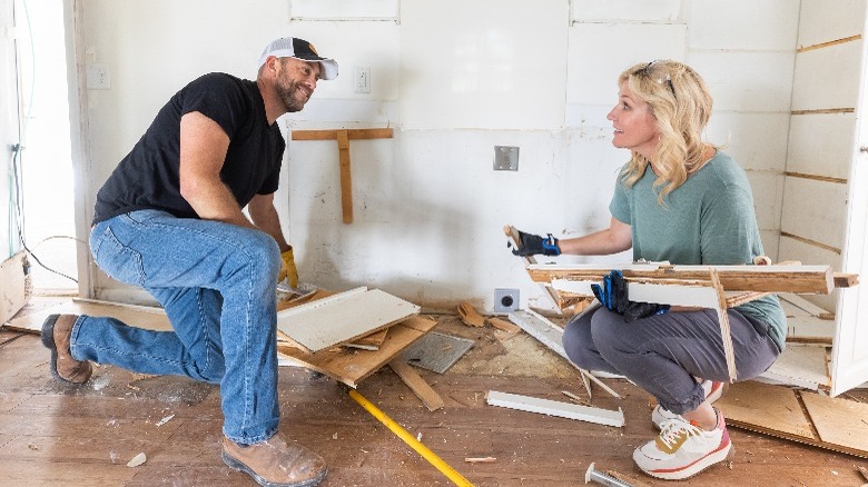 Dave and Jenny Marrs demolishing wood