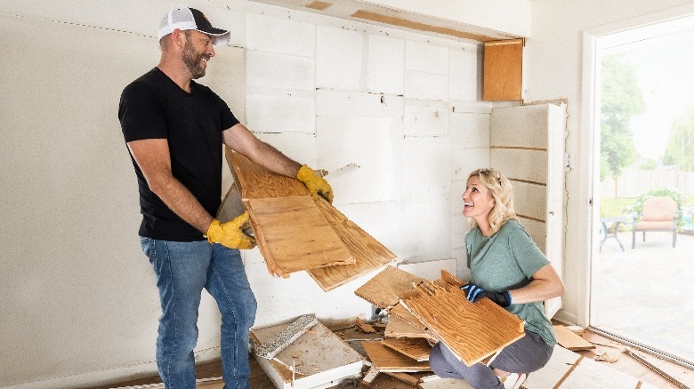 Dave and Jenny Marrs demolishing wood