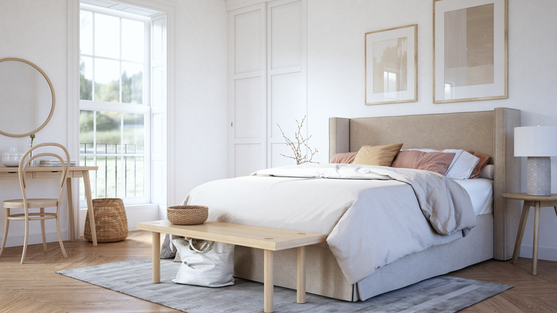 Bright bedroom with neutral bed