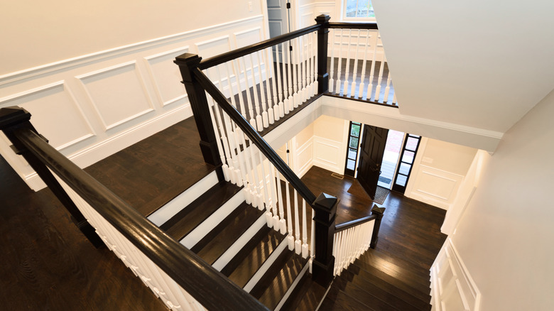 White walls with dark wood flooring