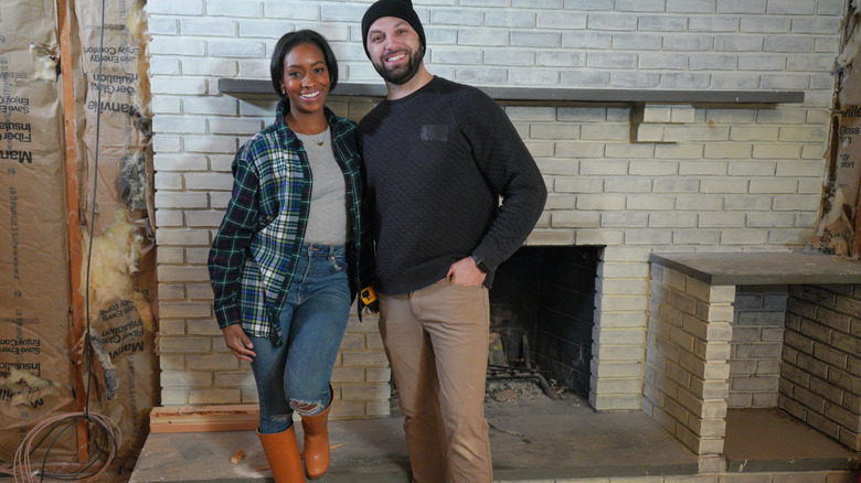 Denese and Mike Butler posing by fireplace