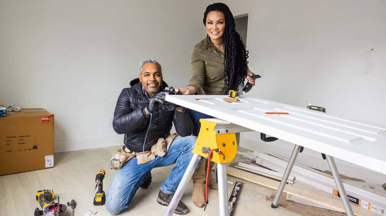 Egypt Sherrod and Mike Jackson working on door