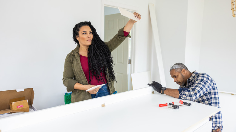 Egypt Sherrod and Mike Jackson working on countertop