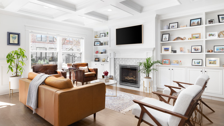 television above fireplace near bookcases