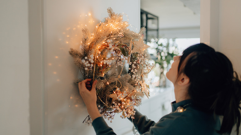 Woman hanging wreath