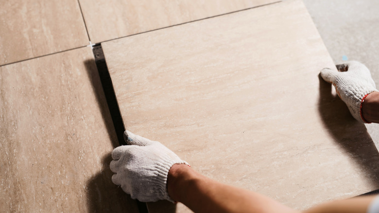 person laying tile