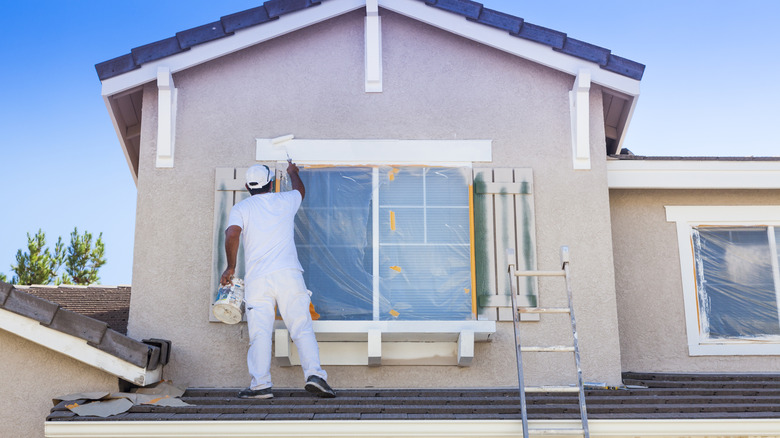 Painter painting the exterior of a home