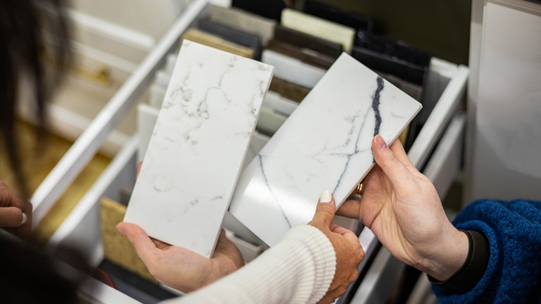 Hands holding two marble samples