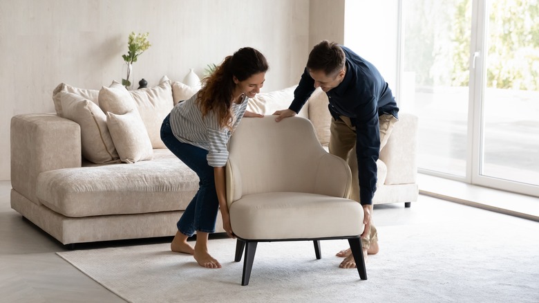 barefoot couple moving furniture