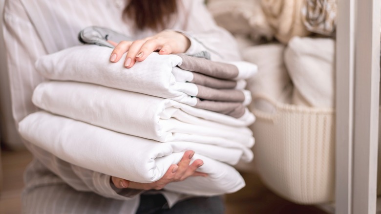 Woman holding folded laundry