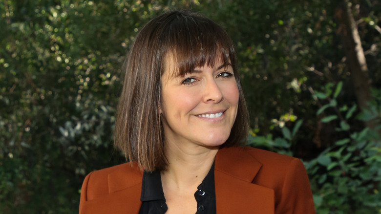 leanne ford smiling against green background