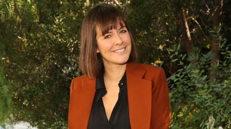 Leanne Ford smiling in front of greenery