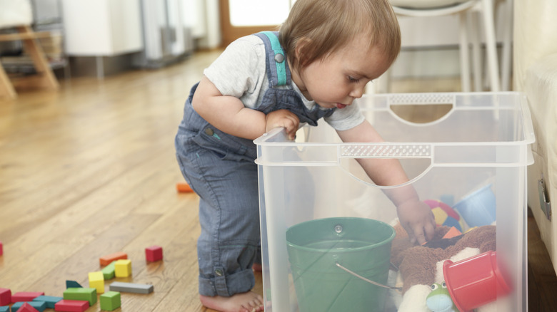 Child digging in toy box