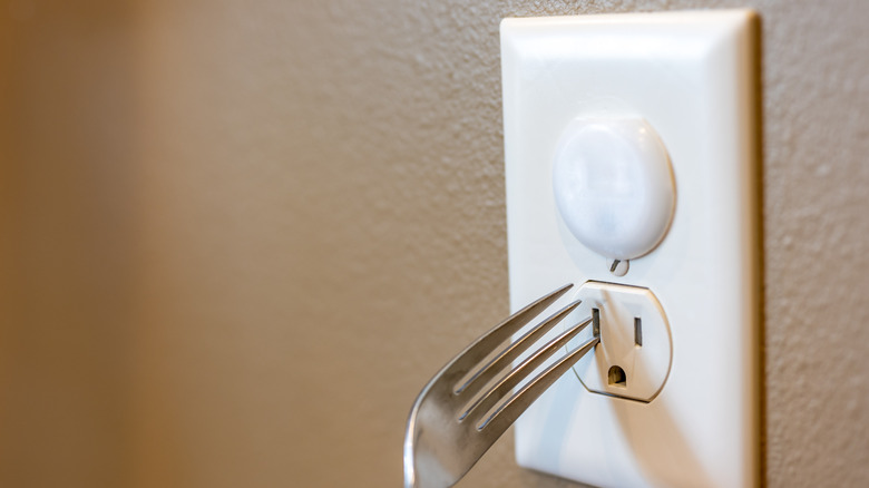 Fork in electrical outlet