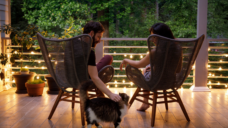 couple on porch with lights