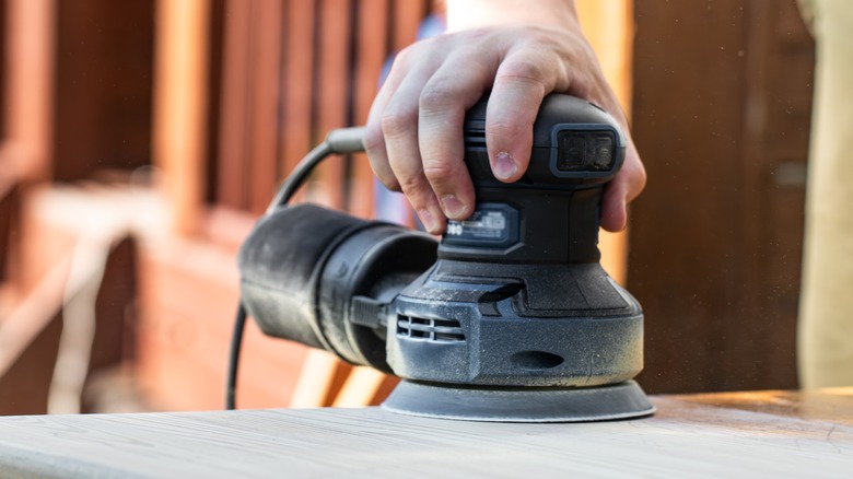 Person sanding wood