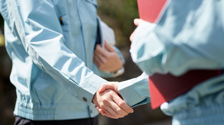 General contractor shaking person's hand