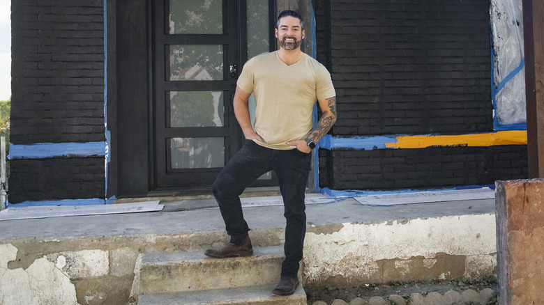 Rico León posing on stairs