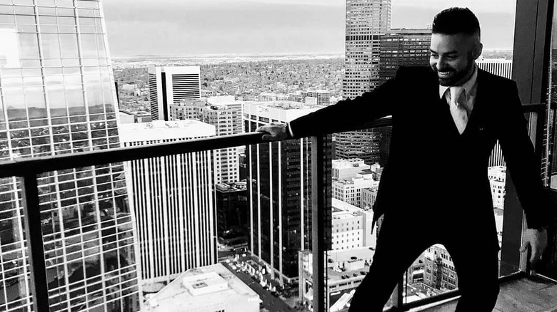 Rico León posing with city skyline