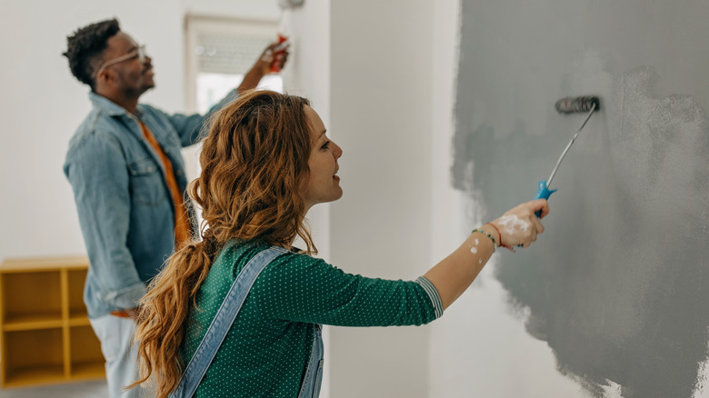 Couple painting wall