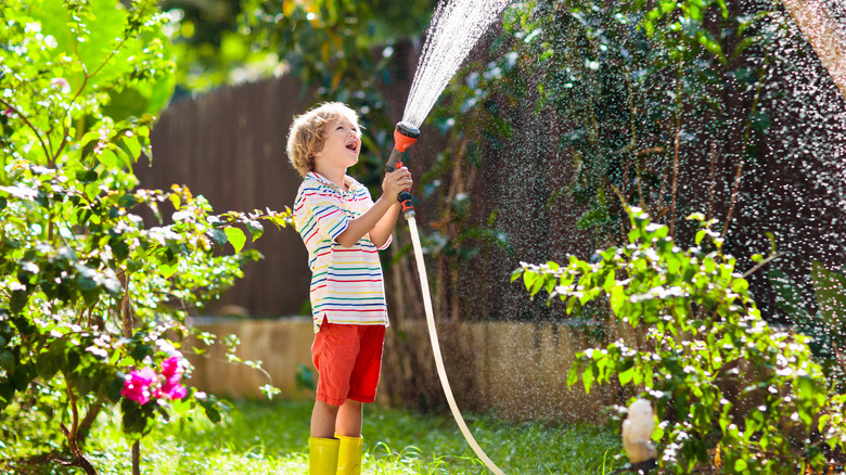 child with hose