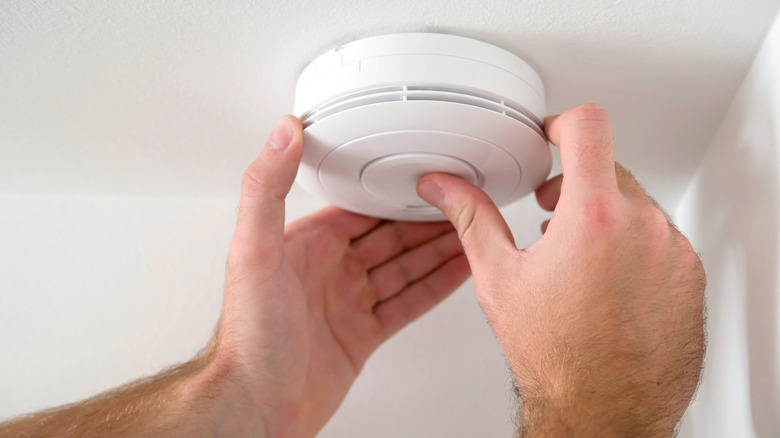 man installing Carbon monoxide alarm 