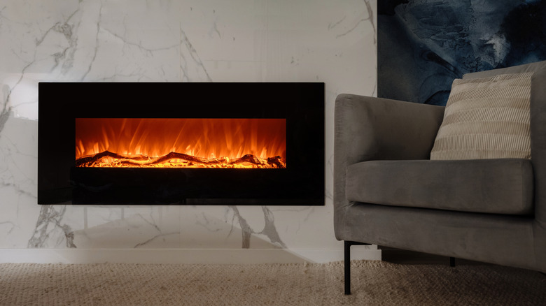 Electric fireplace next to a couch in a house