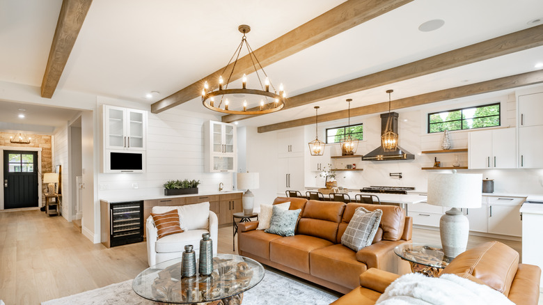 A living room features wood beams on the ceiling