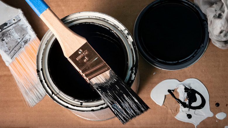 black paint can with paintbrushes