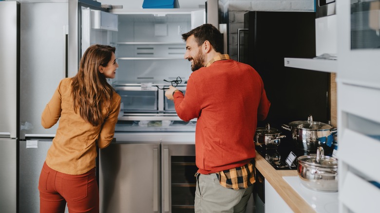 couple looking at fridge