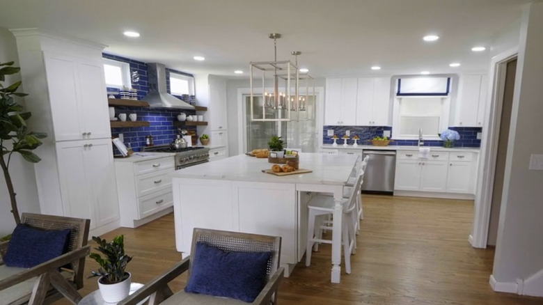 Large modern kitchen with a blue backsplash.