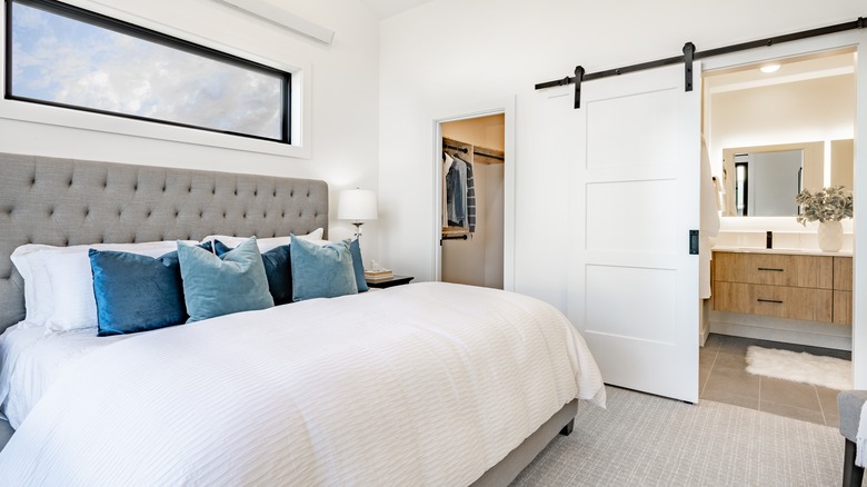 bedroom with barn door to bath