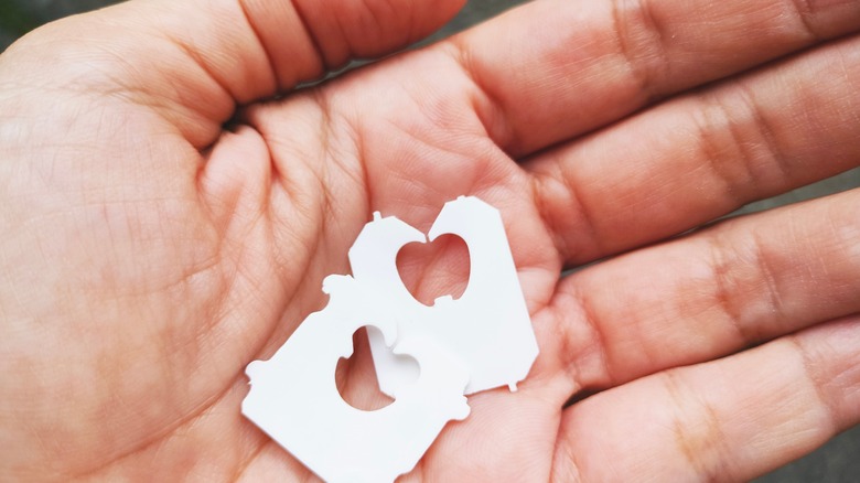 Hand holding pair of bread clips