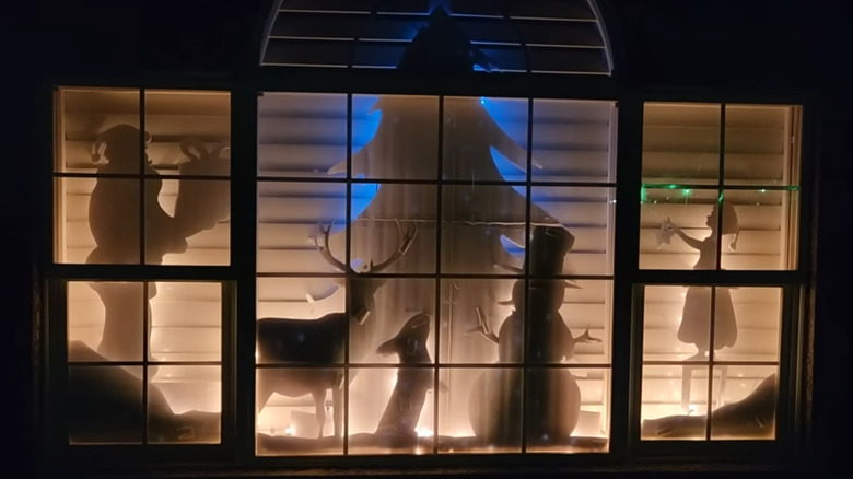 illuminated holiday-themed silhouettes that fill a large window