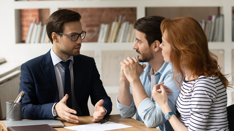 agent speaking with couple