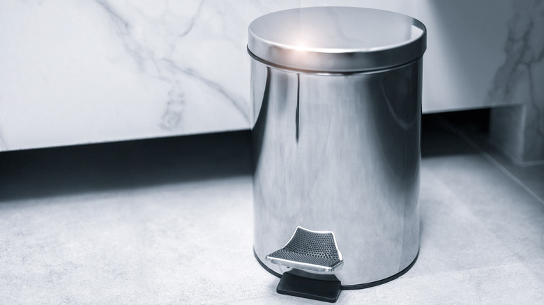 Silver bathroom trashcan, marble floor