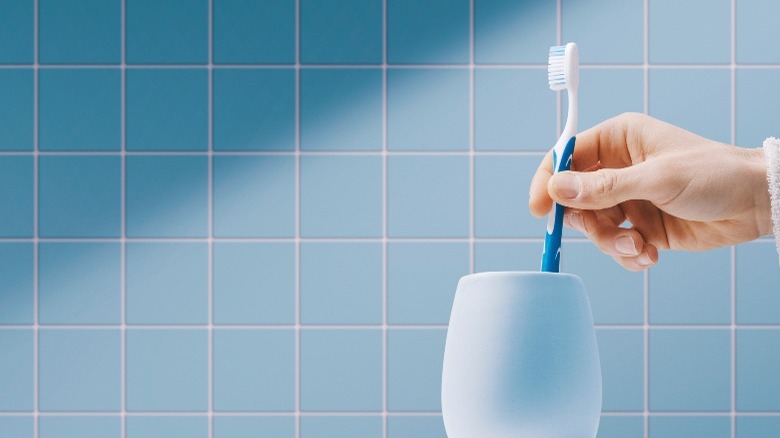 blue toothbrush out of white holder