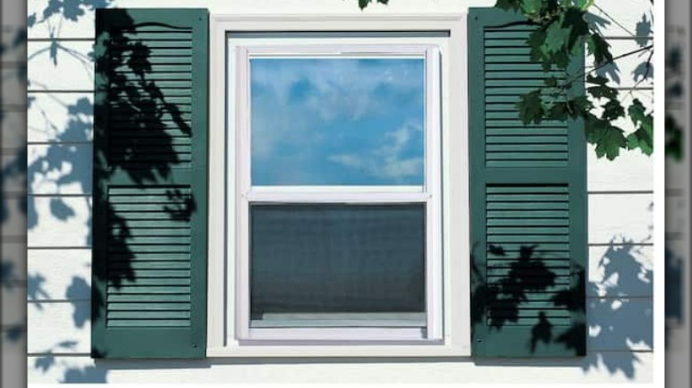 White storm window green shutters