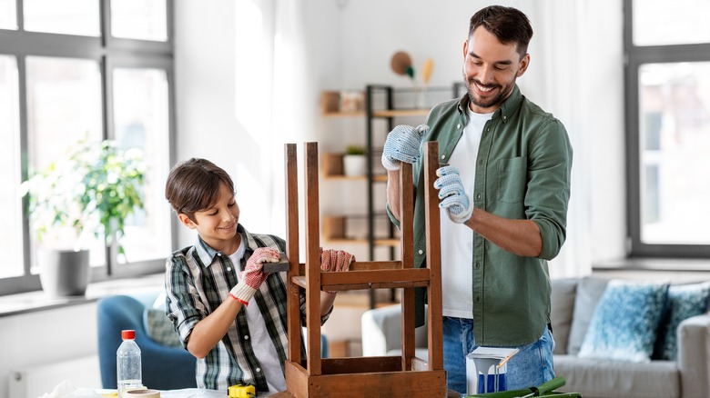 man and boy building table