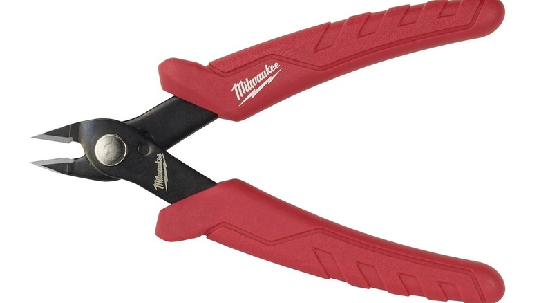 A person using Milwaukee mini flush cutting pliers