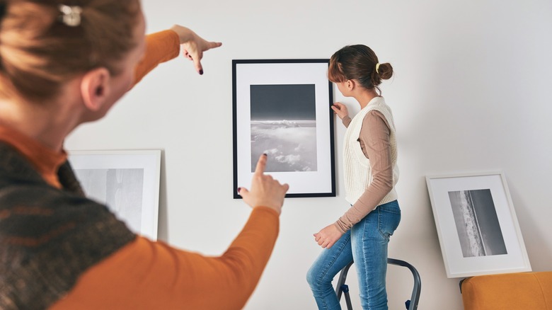 people hanging wall art