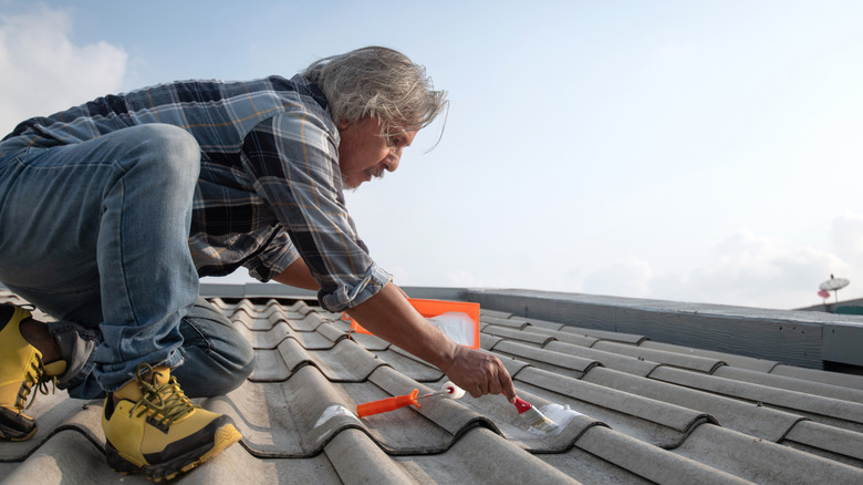 Man repairing a leaking roof himself