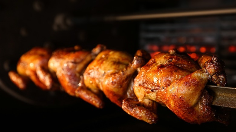 Rotisserie chickens cooking 