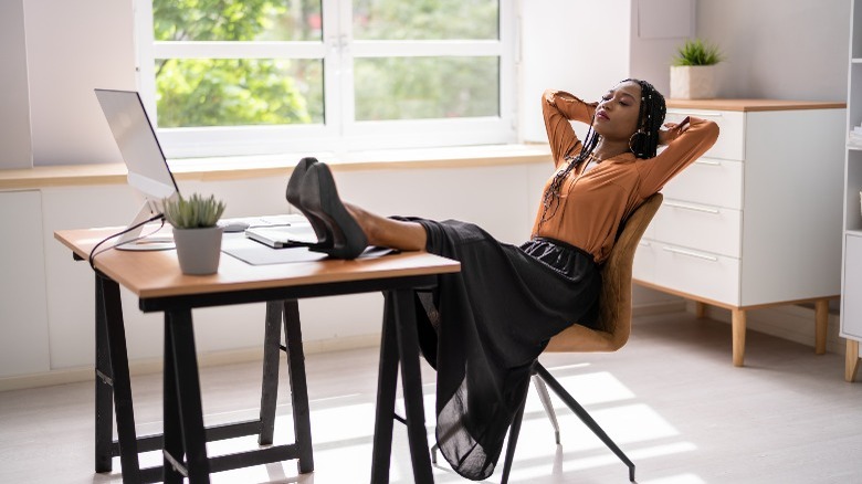 Woman leaning back uncomfortable chair