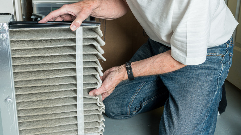 Man changing out furnace filter 