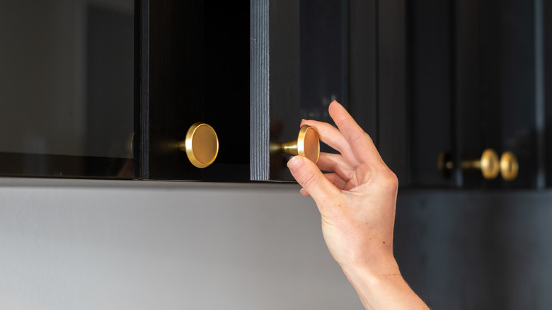 Brass knobs on black kitchen cabinets