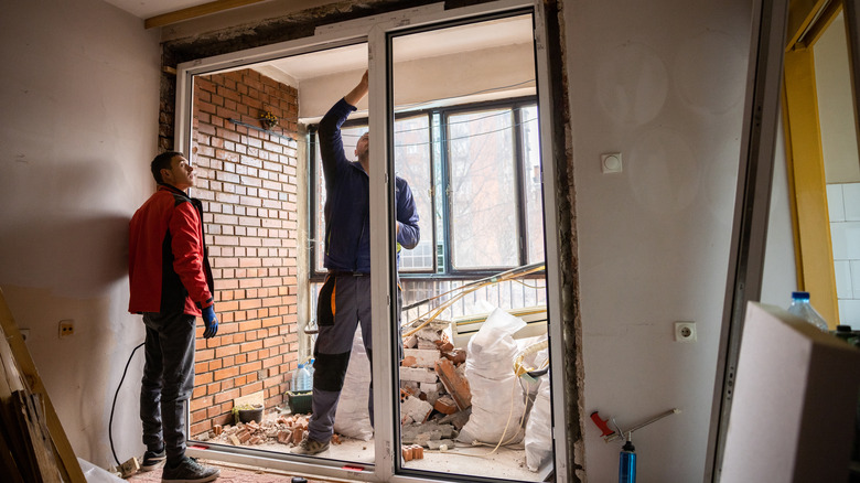 Workers installing sliding door 