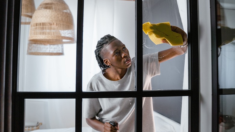 Man cleaning large windows