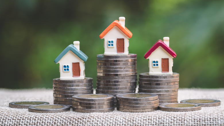 tiny houses on stacks of coins