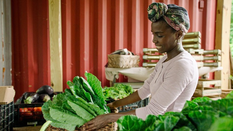 Jamila Norman working with a vegetable harvest